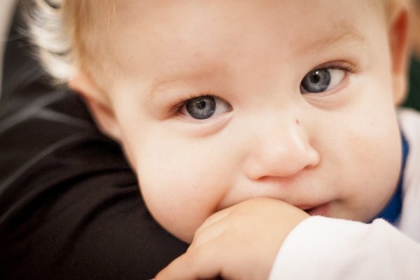 child sucking their thumb