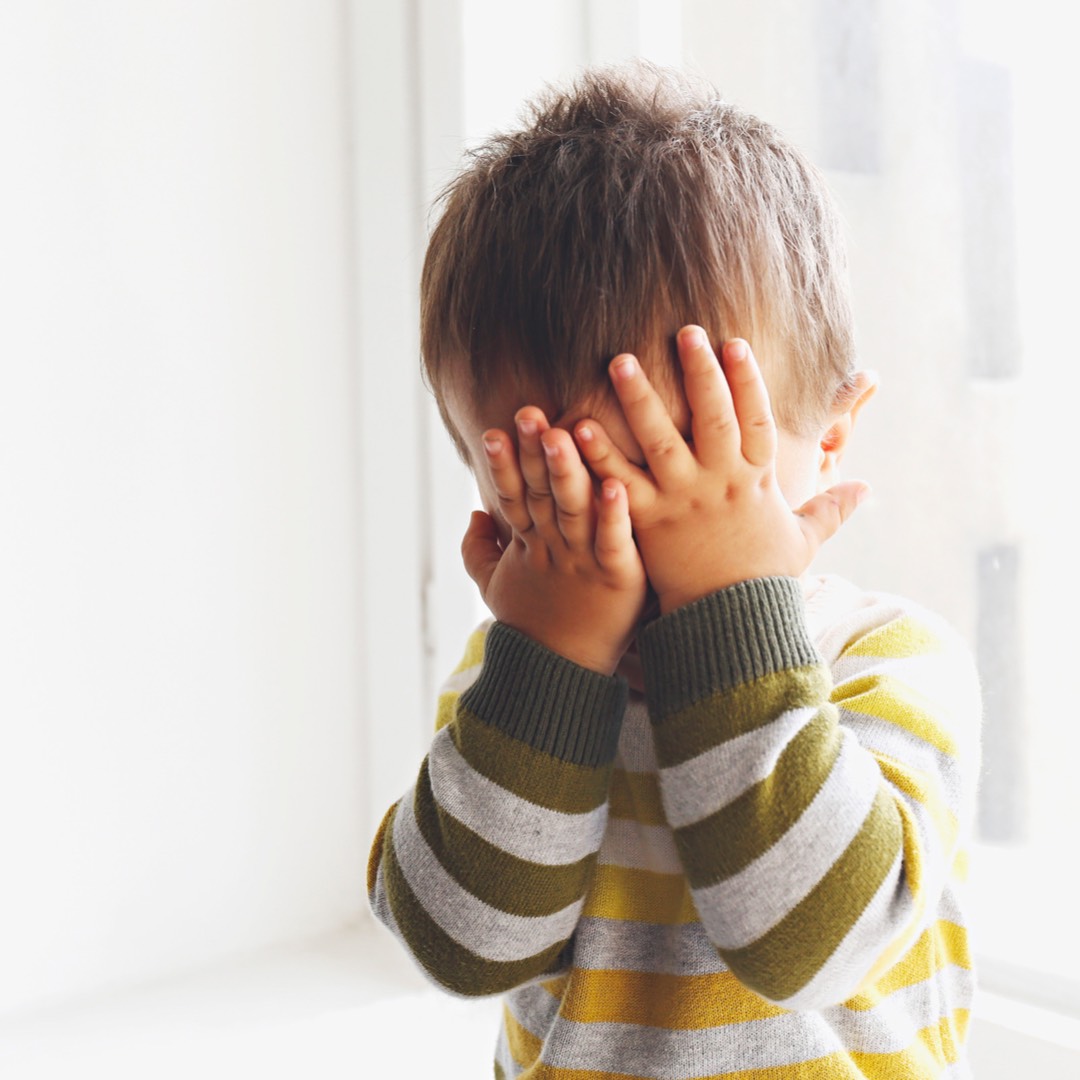 toddler hiding his face