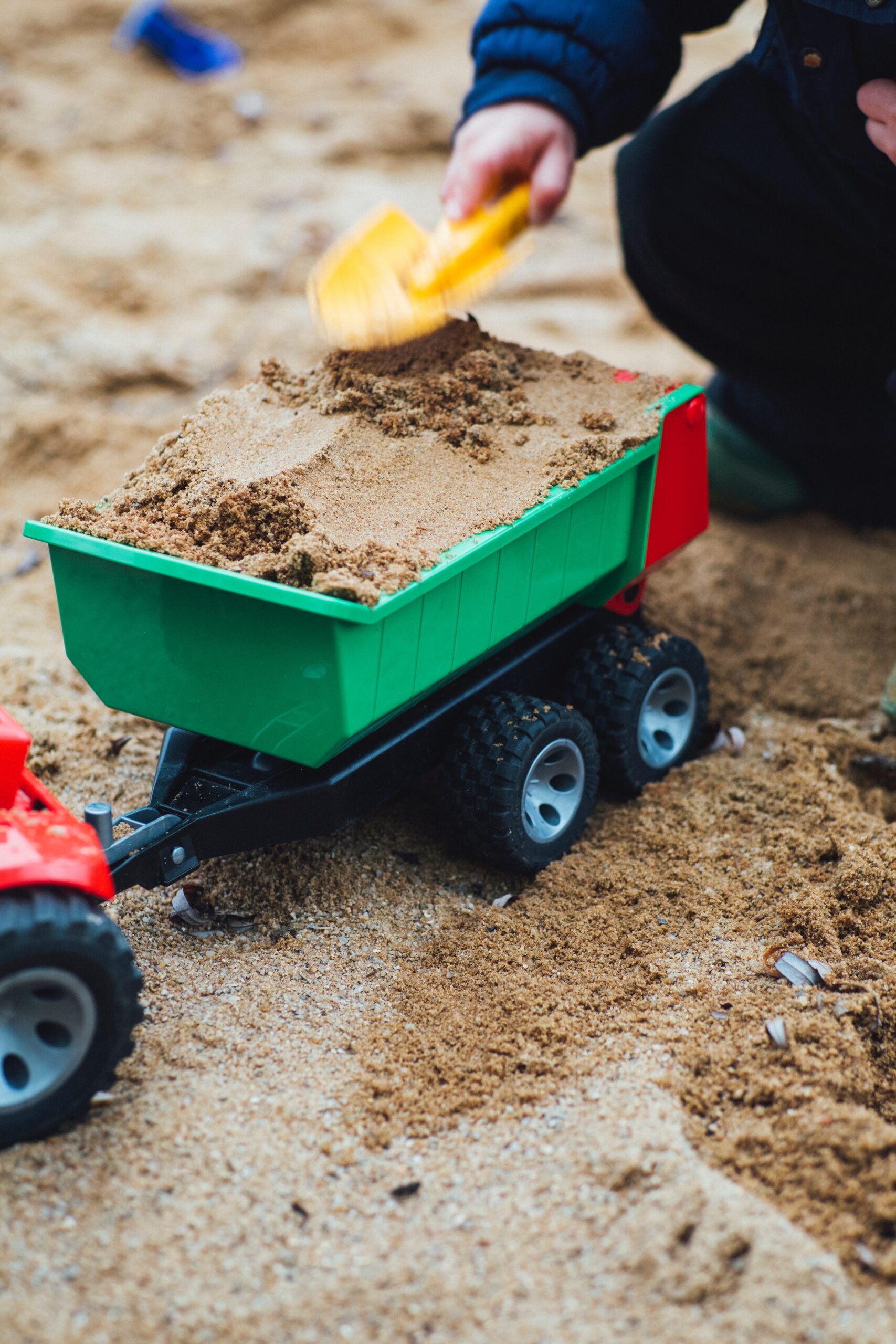 child playing with toy farm